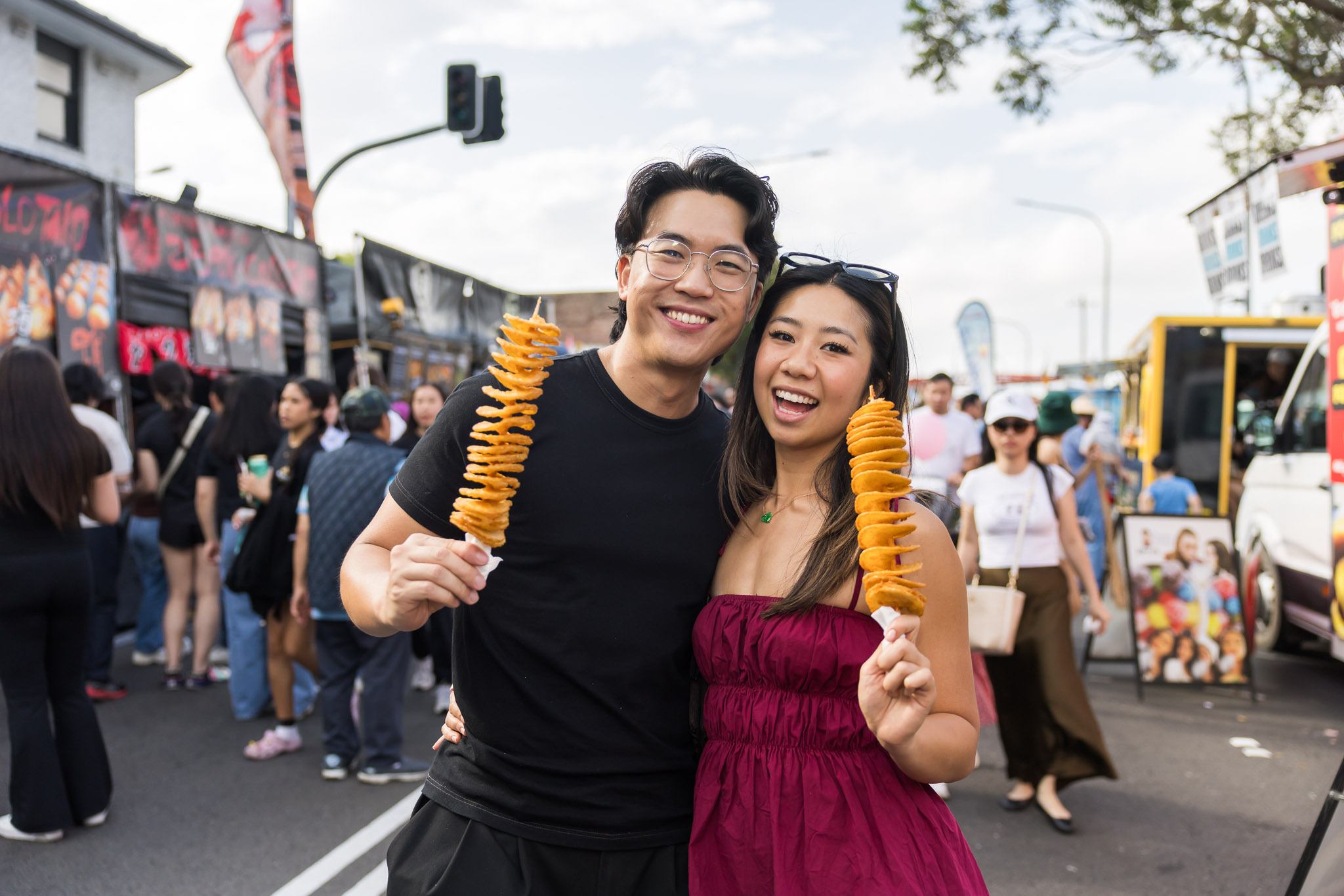Two festival visitors sharing street food in Cabramatta