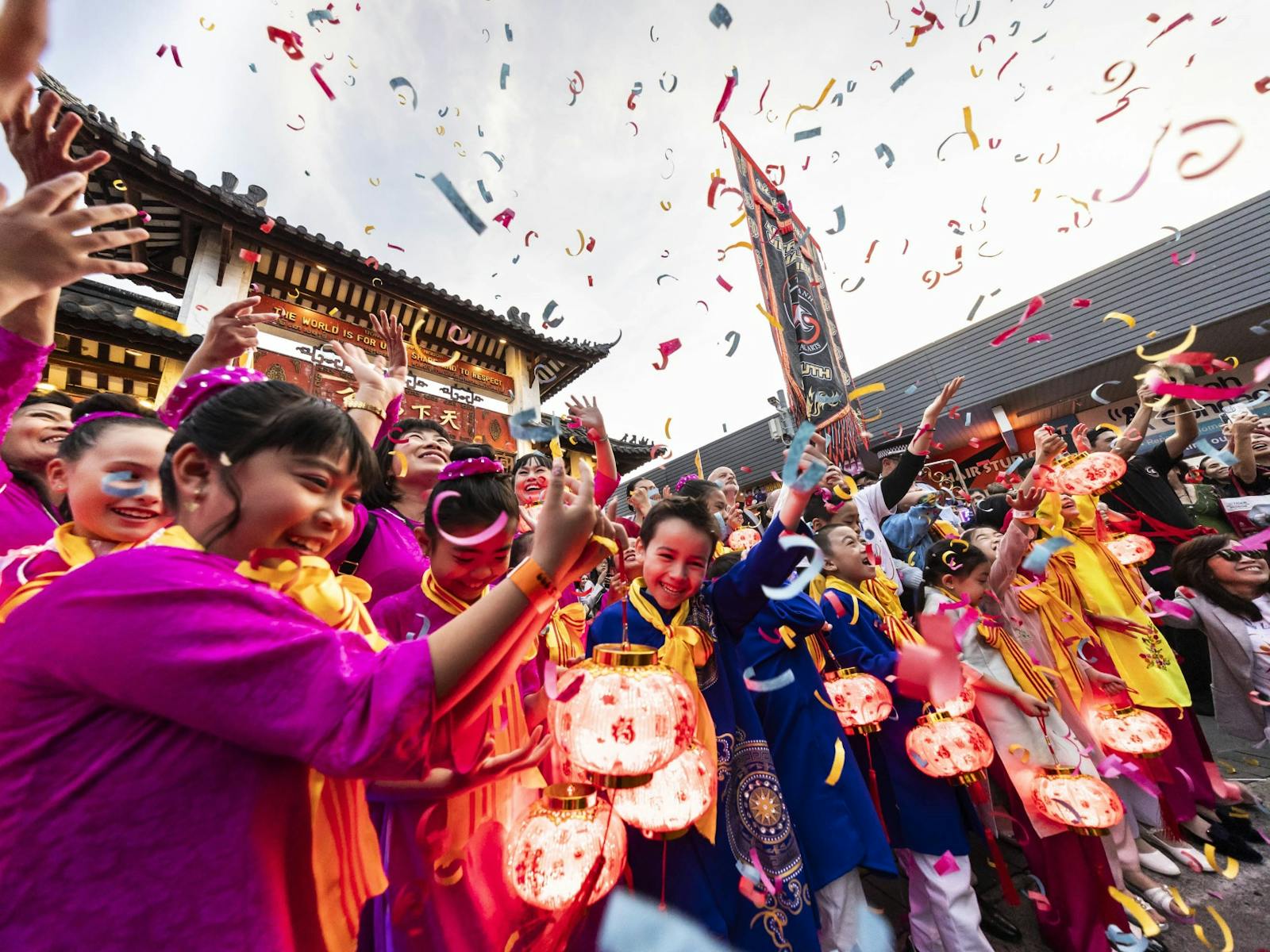 A colourful street parade moving through the Cabramatta Moon Festival
